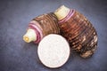 Taro root with half slice on dark background, Fresh raw organic taro root ready to cook Royalty Free Stock Photo