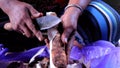 The process of peeling the taro skin with a knife.