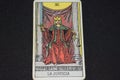 JUSTICE CARD The tarot card number 11 represents JUSTICE in the tarot cards of the major arcana on a black background Royalty Free Stock Photo