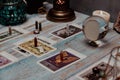 A tarot card reading session depicted with candles, crystals, and mystical accessories on a rustic wooden table. Royalty Free Stock Photo