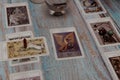 A tarot card reading session depicted with candles, crystals, and mystical accessories on a rustic wooden table. Royalty Free Stock Photo