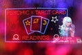 Tarot Card Readings Neon Sign in Window with Psychic Tarot Card Reader in background Royalty Free Stock Photo