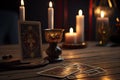 Tarot cards and burning candles on wooden table at night. Fortune telling and reading future. Astrology horoscope