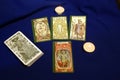 Tarot cards with candles on blue textile