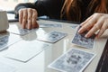 Tarot cards, Tarot card divination, esoteric background. A woman makes a layout on the cards at the table. Divination Royalty Free Stock Photo