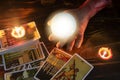 Tarot cards and crystal ball reading psychic by zombie hand candlelight well as divination Royalty Free Stock Photo