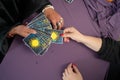 Tarot cards, fortune teller hands on a table background, top view. Future reading concept. Divination. Royalty Free Stock Photo