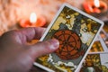 Tarot cards in hand for tarot reading with candlelight background - Magic Spiritual Horoscopes and Palm reading fortune teller Royalty Free Stock Photo
