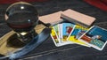 Tarot cards and magic ball on wooden background. Mystical and divination concept