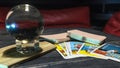 Tarot cards and magic ball on wooden background. Mystical and divination concept