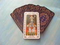 Tarot cards medieval close up with russian title The Chariot Tarot Decks on blue wooden background