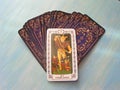 Tarot cards medieval close up with russian title The Fool Tarot Decks on blue wooden background