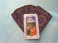 Tarot cards medieval close up with russian title The Moon Tarot Decks on blue wooden background Royalty Free Stock Photo