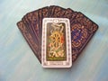 Tarot cards medieval close up with russian title Wheel of Fortune Tarot Decks on blue wooden background