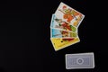 Tarot cards placed on the right of the image. Black surface Royalty Free Stock Photo