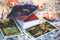 Tarot cards for tarot reading with candlelight background - Magic Spiritual Horoscopes and Palm reading fortune teller concept Royalty Free Stock Photo
