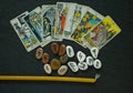 Tarot cards, runes and astrological symbols flat lay on a black