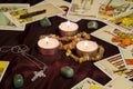 Tarot cards with runes and burning candle