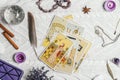 Tarot cards spread face up on white knitted surface with crystal ball, lavender, candles. Minsk, Belarus, 11.10.2021