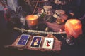 3 Tarot cards spread lying on a black table with magic items. Toned to cold colors