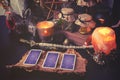 3 Tarot cards spread lying on a black table with magic items. Toned to cold colors
