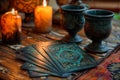 Tarot cards are spread out on a decorated table beside candles and decorative goblets Royalty Free Stock Photo