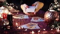 Tarot cards on table near burning candles. Tarot reader or Fortune teller reading on Christmas decoration