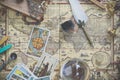 Tarot cards on the world vintage map for fortune and travel concept. Flay lays with