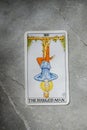 Tarot. XII, 12, twelve. The hanged man. Tarot for divination on a gray marble background