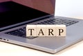 TARP word on wooden block on laptop , business concept