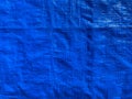 Tarpaulin, crumpled blue tarp. Background of strong, flexible, waterproof material Royalty Free Stock Photo