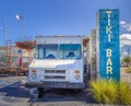 TARPON SPRINGS, FLORIDA - JUNE 30, 2019: Tiki Bar sign next to a beat up old white ice cream truck Royalty Free Stock Photo