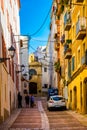 TARRAGONA, SPAIN, DECEMBER 29, 2015: people are strolling through a colorful narrow street in the historical center of Royalty Free Stock Photo