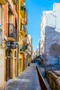 TARRAGONA, SPAIN, DECEMBER 29, 2015: people are strolling through a colorful narrow street in the historical center of Royalty Free Stock Photo