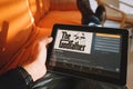 Tarragona, Spain. February 22: Man holding a tablet displaying the godfather movie on the streaming service amazon prime