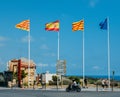 Uropean Union flag, Catalonian, Spanish and Tarragonian flags lined up at historic centre of Tarragonia, Spain