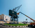 Giant port crane on a roundabout at Port Esportiu de Tarragona, a popular marina