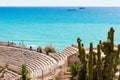 TARRAGONA,SPAIN - MAY 1, 2017: View of the ancient Roman amphitheater and the sea. Cactus in the foreground. Copy space for text.