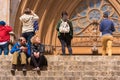 TARRAGONA, SPAIN - MAY 1, 2017: A woman and a man are sitting on the steps of the cathedral Catholic cathedral.