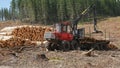 TARRALEAH, AUSTRALIA- JANUARY, 6, 2017: oblique view of a log loader unloading pine logs