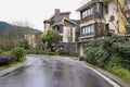 Tarred road and dwelling buildings after rain