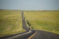 A tarred road leading to the top of the mountain is flanked by golden prairie