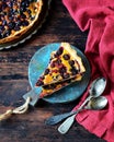 Tart with berries and sour cream filling on a dark wooden background Royalty Free Stock Photo