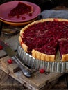 Tart, cake with red cranberries and walnuts on wooden background. Berry pie. Space for text