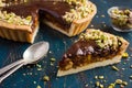 Tart with caramel, chocolate and nut