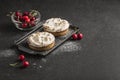 Tart with cherry filling with cocoa cream on a black plate with cherry berries on a dark background Royalty Free Stock Photo