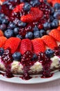 Tart with fresh strawberries, blueberries and cherry jam. Vertical photo. Royalty Free Stock Photo