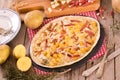 Tart with fried potato, raclette cheese and smoke flavour bacon. Royalty Free Stock Photo