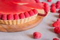 Tart, pie, cake with jellied and fresh raspberry on the light concrete background