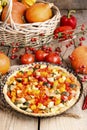 Tart with pumpkin and other vegetables in autumn setting